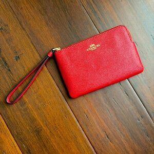 Coach wristlet (red); never been used; has two compartments for cards